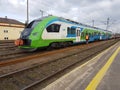 Modern passenger train en route. Worker inspects the railway line. High-speed train with motion blur. Train at the railway station Royalty Free Stock Photo