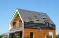 Modern Passive House Exterior. Modern energy efficiency house with skylight windows and solar panels on the roof top Royalty Free Stock Photo