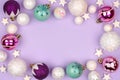 Pastel Christmas bauble frame over purple