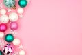 Pastel Christmas bauble side border over a pink background Royalty Free Stock Photo