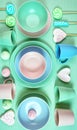 Modern pastel pink, green and blue ceramic tableware on pale green. Royalty Free Stock Photo