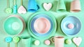 Modern pastel pink, green and blue ceramic tableware on pale green. Royalty Free Stock Photo