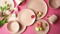 Modern pastel pink tableware on pink background. Creative concept layout.