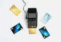 Modern payment terminal and credit cards on white background Royalty Free Stock Photo