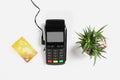 Modern payment terminal, plant and credit card on white background Royalty Free Stock Photo