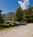 Modern pedestrian bridge in the middle of the mountains of Italian Switzerland, allowing you to cross the Ticino River