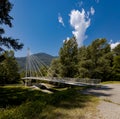 Modern pedestrian bridge in the middle of the mountains of Italian Switzerland, allowing you to cross the Ticino River