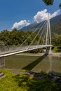 Modern pedestrian bridge in the middle of the mountains of Italian Switzerland, which allows you to cross the Ticino river