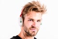 Modern people concept. Man tousled hairstyle wear plastic earphones gadget. Enjoy music everywhere you go. Download Royalty Free Stock Photo