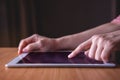 Modern Person Using Digital Tablet on Wooden Table