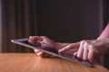 Modern Person Using Digital Tablet on Wooden Table