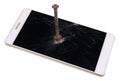 Modern phone is through punched by a rusty iron nail. Now nobody Royalty Free Stock Photo