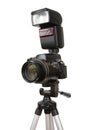 Modern photo camera with flash on tripod Royalty Free Stock Photo