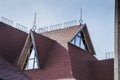 Modern photo of a rural rustic facade  balcony of a stylish cottage . Window of mansard of the wooden house against the summer blu Royalty Free Stock Photo