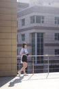 Modern photographer happy girl in a leather cut for the camera against the backdrop of skyscrapers. woman wearing a blue shirt,