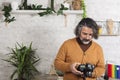 Modern photographer viewing photos on a digital camera in the office