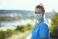 Modern physician woman in uniform outdoors on city street