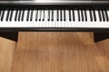 Modern piano with black and white keys over floor. Space for text