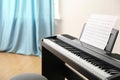 Modern piano with music sheets