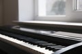 Modern piano near window in room