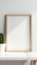 Modern picture frame mockup, white desk, cactus, elegant, content creation Royalty Free Stock Photo