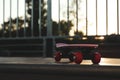 Modern pink skateboard with red wheels on top of ramp outdoors. Space for text Royalty Free Stock Photo