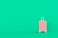 Modern pink suitcases bag on green background. Travel concept. Vacation trip. Copy space. Minimal style.