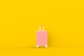 Modern pink suitcases bag on yellow background. Travel concept. Vacation trip.