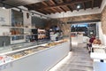 Modern pizzeria interior with large glass counters with freshly baked products in the Bergamo Old Town