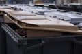 Modern plastic garbage bins standing side by side filled with trash. Selective focus image