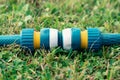 Modern plastic hose connector for quick connection of garden watering hoses lying on the grass close up Royalty Free Stock Photo