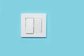 Modern plastic light switch on blue wall, space for text Royalty Free Stock Photo