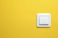 Modern plastic light switch on orange background. Space for text Royalty Free Stock Photo