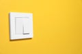 Modern plastic light switch on orange background. Space for text Royalty Free Stock Photo