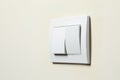 Modern plastic light switch on white wall, closeup. Space for text Royalty Free Stock Photo