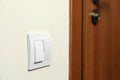 Modern plastic light switch on white wall indoors Royalty Free Stock Photo