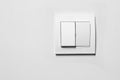 Modern plastic light switch on white wall, space for text Royalty Free Stock Photo