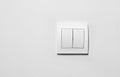 Modern plastic light switch on white wall, space for text Royalty Free Stock Photo