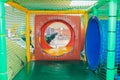 Modern playground indoor. Kids jungle in a play room. Round tunnel in children gym. Royalty Free Stock Photo