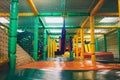 Modern playground indoor. Kids jungle in a play room. Round tunnel in children gym.