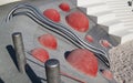 modern Playground with a metal slide inscribed in a contemporary landscape design stairs made of red hemispheres, made on the Royalty Free Stock Photo