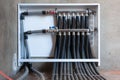 Modern plumbing manifold system tubing for house water distribution, control valves home water pipe, close-up human hand Royalty Free Stock Photo