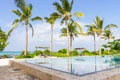 Modern pool with palm trees in the background. Tropical hotel resort. Empty paradise. Luxury villa outdoor.