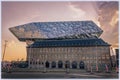 Modern port headquarters in Antwerp, Belgium at sunset