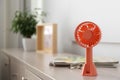 Modern portable fan on wooden table indoors, space for text. Summer heat Royalty Free Stock Photo