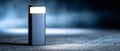 Modern portable LED light standing on textured surface with dark blurred background and soft focused illumination Royalty Free Stock Photo