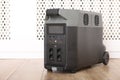 Modern portable power station on floor indoors Royalty Free Stock Photo