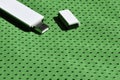 A modern portable USB wi-fi adapter is placed on the green sportswear made of polyester nylon fibe Royalty Free Stock Photo