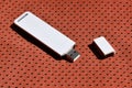 A modern portable USB wi-fi adapter is placed on the red sportswear made of polyester nylon fibe Royalty Free Stock Photo