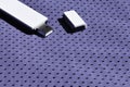 A modern portable USB wi-fi adapter is placed on the violet sportswear made of polyester nylon fibe Royalty Free Stock Photo